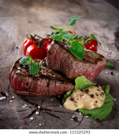 Grilled bbq steaks with fresh herbs and tomatoes