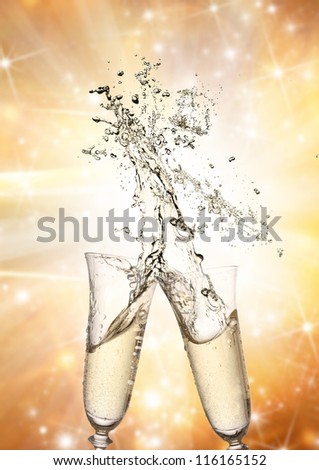 Pair of champagne flutes making a Champagne splash