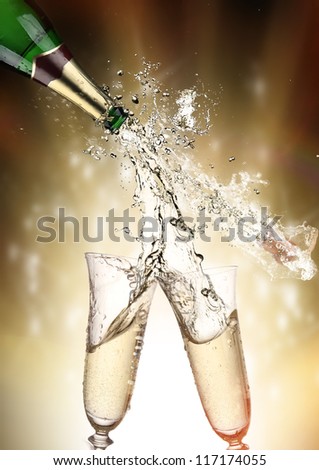 Pair of champagne flutes making a Champagne splash