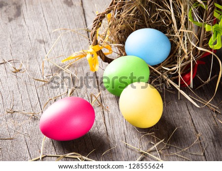 Colorful easter eggs in brown basket