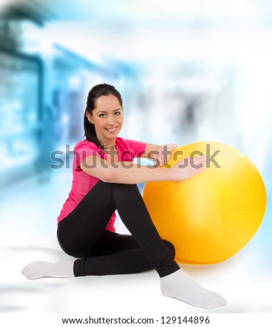 Happy young fitness woman with punch ball