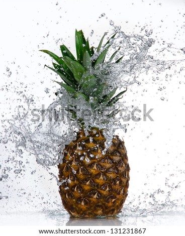 Pineapple with water splash isolated on white