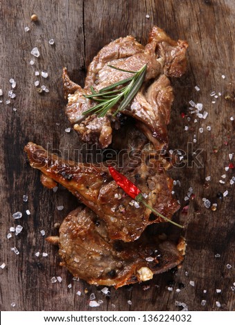 Delicious lamb chops on wooden table
