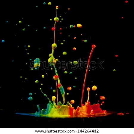 Colorful paint splashing isolated on black