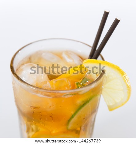 Glass of ice tea with ice-cubes on white background