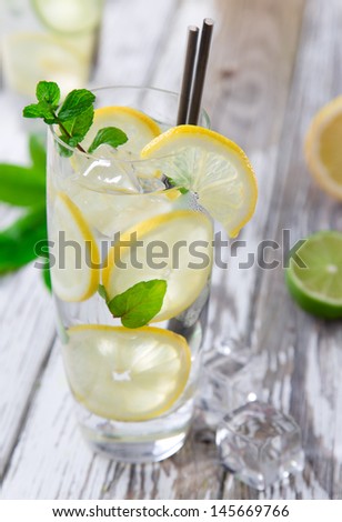 Cocktail with ice and lemon slices isolated on white background