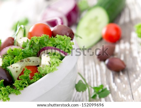Fresh salad on wooden background