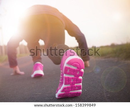 Runner feet running on road. Shoe close-up.