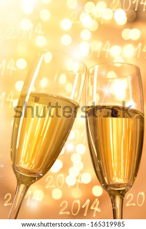 Pair of champagne flutes over gold background