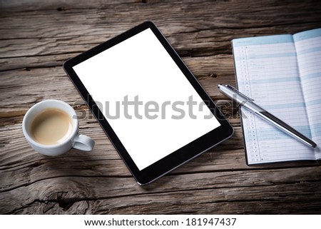 Workspace with coffee cup, tablet pc and note paper on old wooden table
