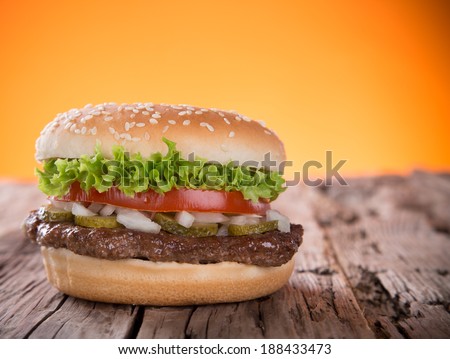 Delicious hamburger on wooden background