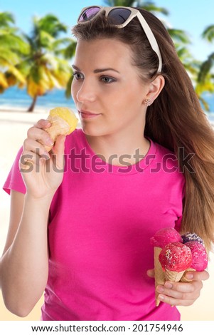 Young pretty girl with ice cream on sandy beach.