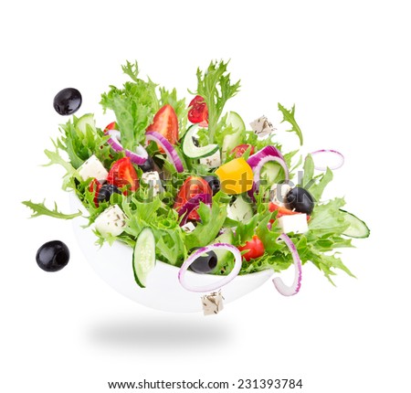 Fresh salad with flying vegetables ingredients isolated on a white background.
