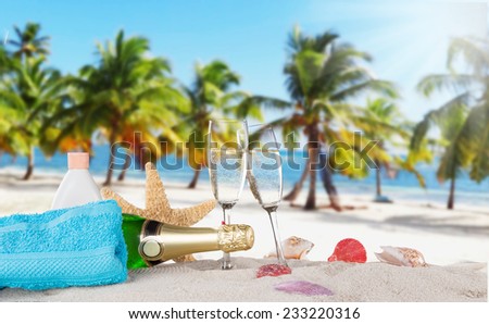 Champagne flutes on sunny beach, celebration theme.