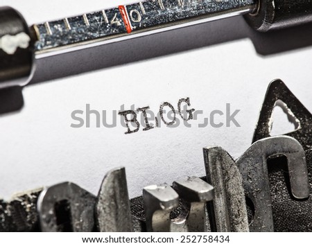 Typewriter with white paper page on wooden table. sample text Blog.