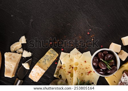 Various types of cheese on stone table, still-life.