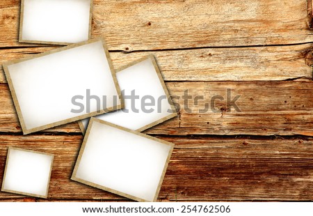 Vintage blank photo frames on wooden background