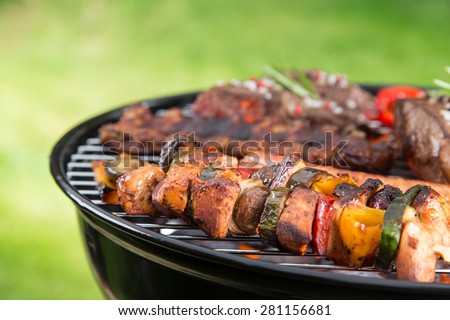 Delicious meats on garden grill, barbecue time.