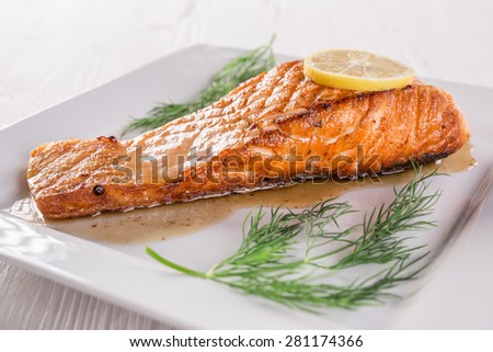 Salmon steak on white plate, close-up