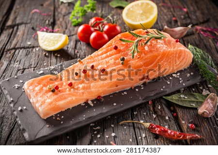 Delicious salmon steak on wooden table, close-up