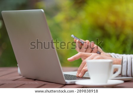 Woman with notebook on the garden, working outside.