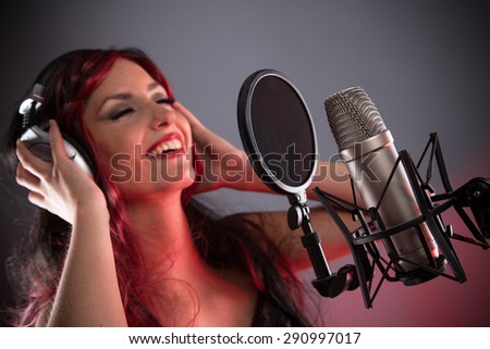 Young singer screaming on the studio microphone