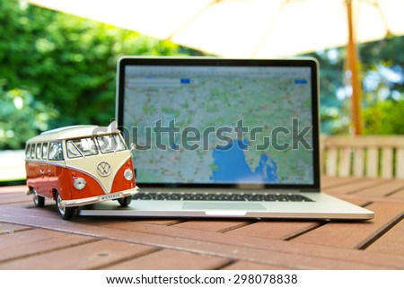PRAGUE, CZECH REPUBLIC - JULY 10, 2015: Miniature VW Bulli 1962 on laptop. The cult car of the Hippie generation and it remained the status vehicle of the high wave surfers.