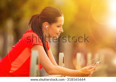 Brunette young woman listening to music.