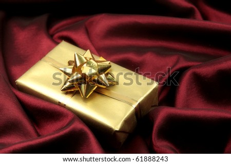Elegant Red Satin Background with Golden gift. Luxury theme