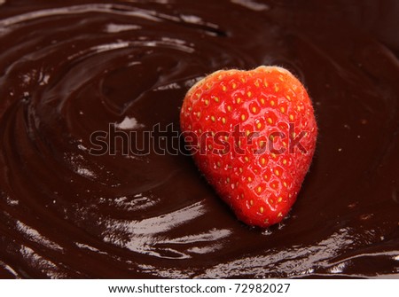 Strawberry dipped in melting dark chocolate