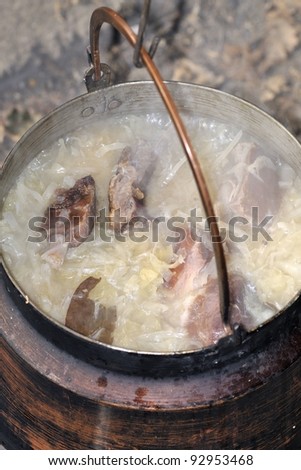 Sauerkraut cooked with dried pork ribs in a copper kettle