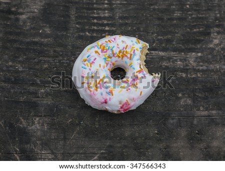 Bitten donut on a wooden table