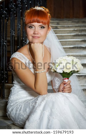 Red haired young beautiful bride with green eyes