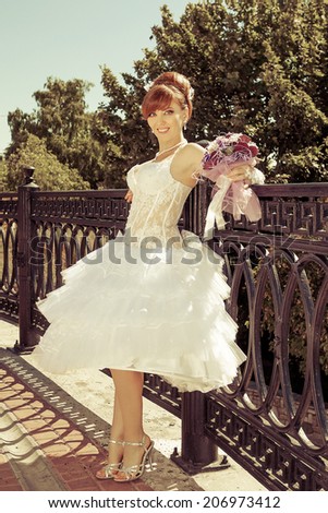 Beautiful redhead bride with big eyes on a sunny day
