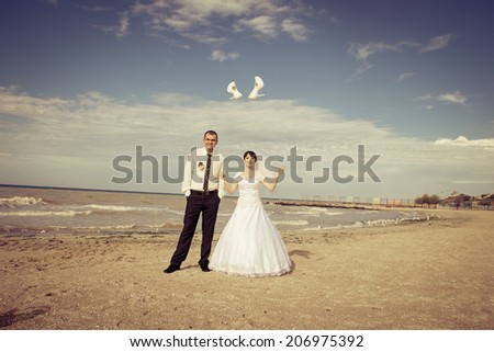 Cheerful couple  groom and bride threw shoes
