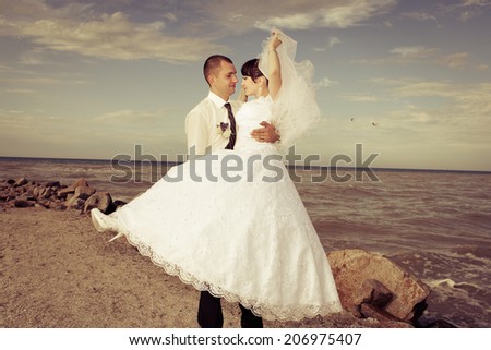 funny bride and groom blue background laughing and having fun