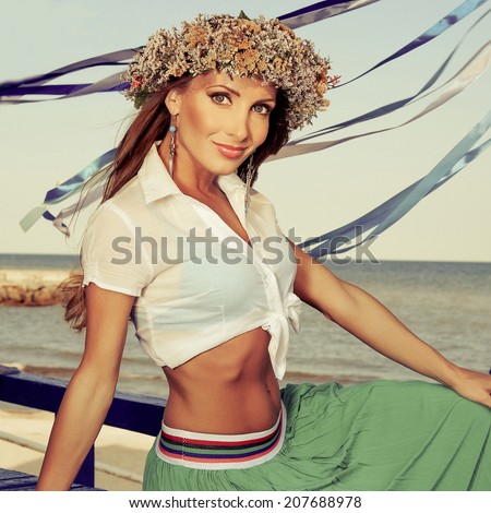 beautiful Woman with a wreath  on a background of the sea