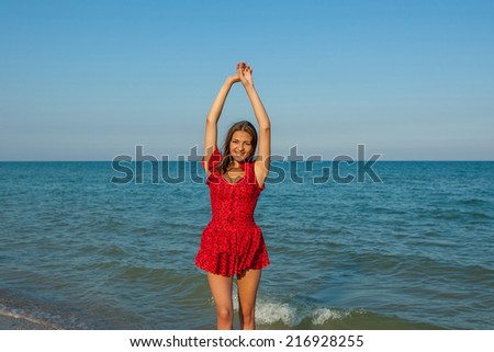 Young happiness woman in red dress on the sea Beach