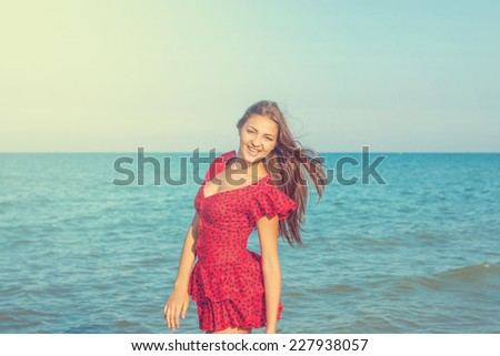Young happiness woman in red dress on the sea Beach