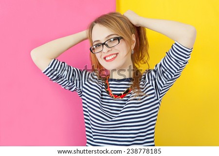 Fashion stunning closeup portrait of pretty attractive nice girl with red lips and glasses posing on pink-yellow vivid color  background