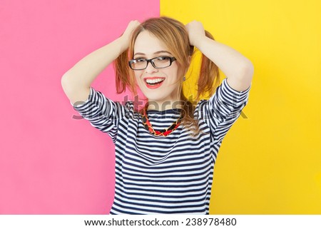 Fashion stunning closeup portrait of pretty attractive nice girl with red lips and glasses posing on pink-yellow vivid color  background