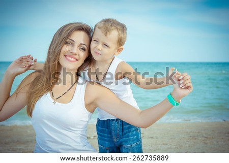 Happy family. Young happy beautiful  mother and her son having fun on the beach. Positive human emotions, feelings, emotions.