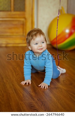 Little cheerful child plays. Happy sweet cute face.