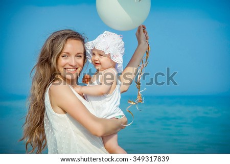 Happy family. Mother and her daughter having fun on the beach. Positive human emotions, feelings.