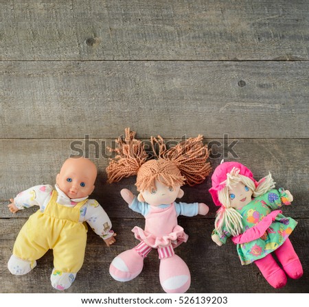 Dolls on wooden background. top view. copy space.