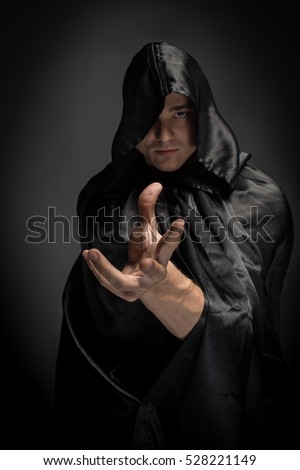 Portrait of a brutal man in a black robe