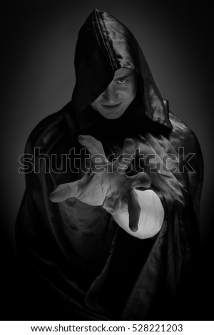 Portrait of a brutal man in a black robe