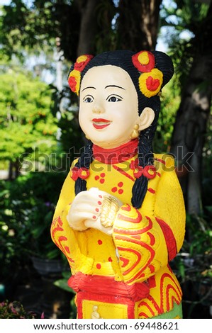 A colorful-dress chinese girl statue with greeting action