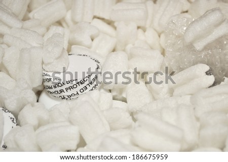 This order fulfillment images includes biodegradable packing peanuts around a bottle of vitamins.