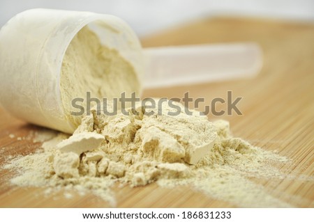 Protein powder or weight loss powder spilling out of a measuring scoop.